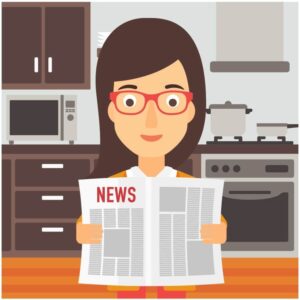 Woman reading newspaper in kitchen with kitchen appliances