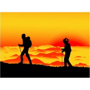 Man climbing a mountain by himself at sunset